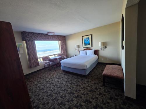 a hotel room with a large bed and a window at Seagrass Oceanfront Inn in Newport