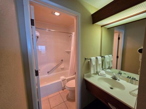 a bathroom with a sink and a shower and a toilet at Seagrass Oceanfront Inn in Newport
