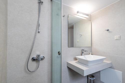 a bathroom with a sink and a shower at Creta Elena in Chania
