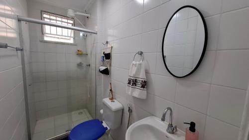a bathroom with a sink and a mirror and a toilet at Ilhéus Temporada in Ilhéus