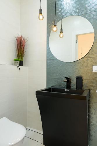 a bathroom with a black sink and a mirror at Rusulica Trogir in Seget Vranjica