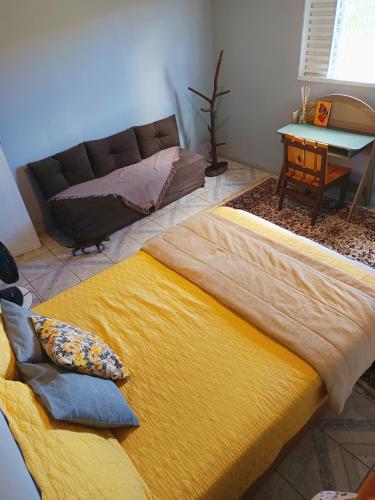 a large bed in a living room with a couch at Hostel do Cerrado in Cavalcante