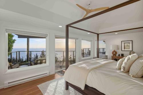 a bedroom with a large bed and a balcony at Boxer Bay in Tillamook