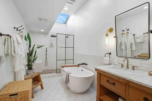 a white bathroom with a tub and a sink at Boxer Bay in Tillamook