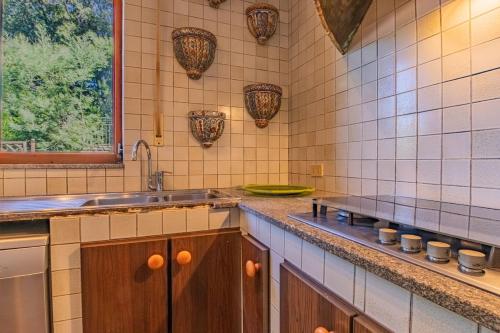 a kitchen with a sink and a counter top at Villa la Paolina in Marciana