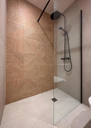 a shower with a glass door in a bathroom at La Plana allotjament rural in Aviá