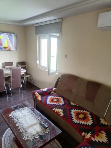 a living room with a couch and a table at Suncani breg in Ljig