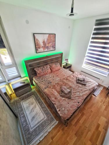 a bedroom with a large bed in a room at Lasta Apartman Sokobanja in Soko Banja