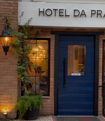 a blue door in front of a hotel da practice at Hotel da Praia in Vila Velha