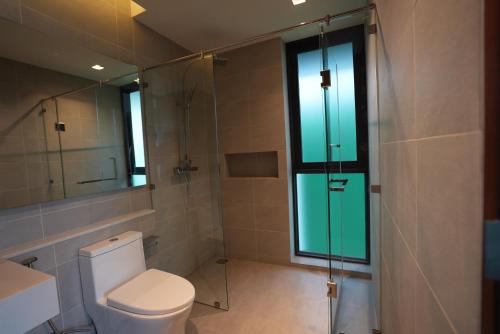 a bathroom with a toilet and a glass shower at 030vollsamui in Ban Bang Po