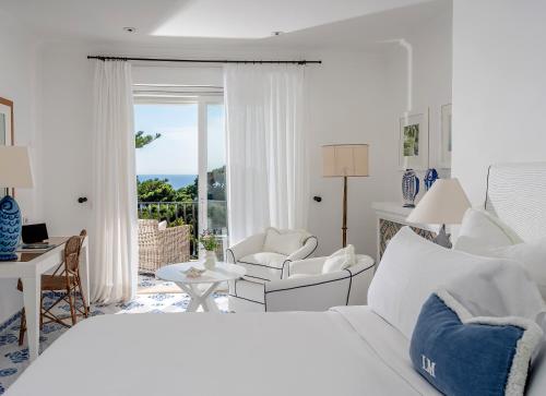 a bedroom with a bed and a living room at Hotel La Minerva in Capri