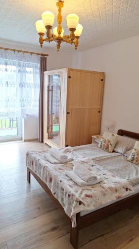 a large bed in a room with a large window at Górski Zakątek in Meszna