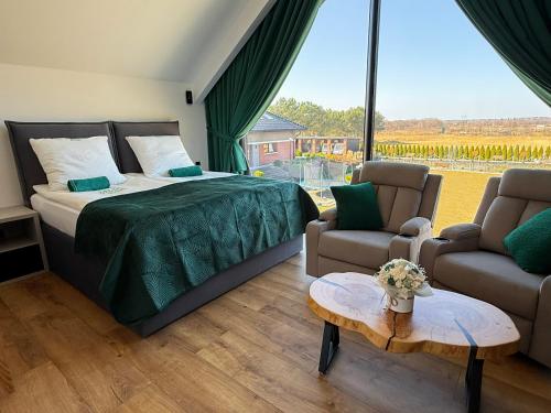 a bedroom with a bed and a large window at POKOJE GOŚCINNE U MIKOŁAJA in Pękanino