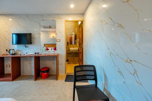 a room with a counter and a chair in a room at White Forest - PV Hotels in Pondicherry