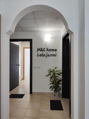 a hallway with a door and a potted plant at M&C Home in Letojanni