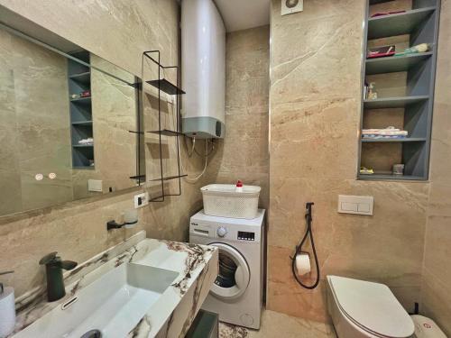 a bathroom with a washing machine and a sink at Luxury Apartment in Shkodër