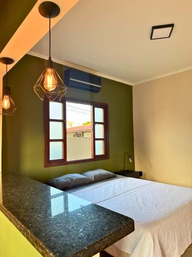 a bedroom with a bed and a window at Pousada Barcelos Florianópolis in Florianópolis