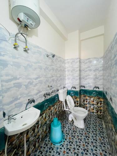 a bathroom with a toilet and a sink at Hotel The regal inn in Varanasi