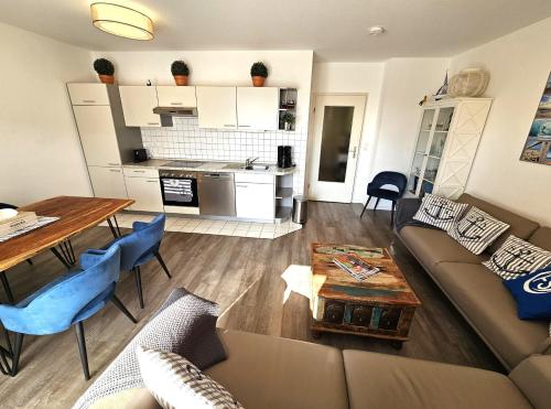 a living room and kitchen with a couch and a table at FeWo "Seebär" Whg2 in Dahme