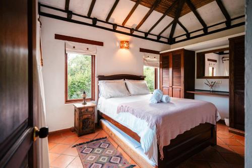 a bedroom with a bed in a room with a window at Cabañas Sol y Luna in Villa de Leyva