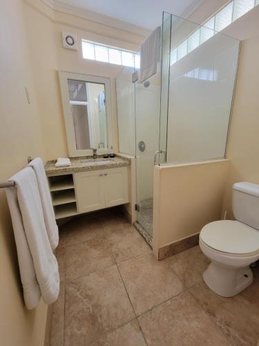 a bathroom with a shower and a toilet and a sink at Clariston in Bridgetown
