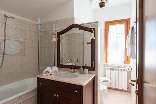 a bathroom with a sink and a tub and a toilet at Vecchia San Giovanni - YourPlace Abruzzo in Fossacesia