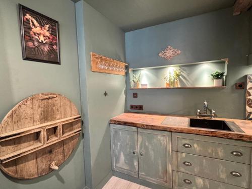 a bathroom with a wooden sink and a mirror at Le 16 authentique au cœur de la ville in Lisieux