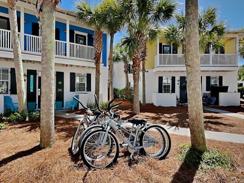 two bikes parked in front of a house with palm trees at Bungalows at Seagrove #142 in Seagrove Beach