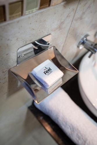 a tray with a book on it next to a sink at Feel Buenos Aires Apartments in Buenos Aires