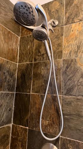 a shower head on the wall of a bathroom at Private Rooms, Shared Bath in a Private Home Minutes From Logan Airport in Boston