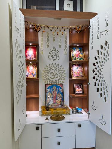 a room with a temple with paintings on the wall at Aanchal Palace Hotel in Jaipur