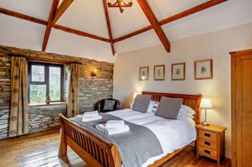 a bedroom with a large bed in a room at Tawnawood in Cardinham