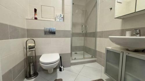 a bathroom with a toilet and a sink at THE RIVERSIDE APARTMENT with Balcony in Prague