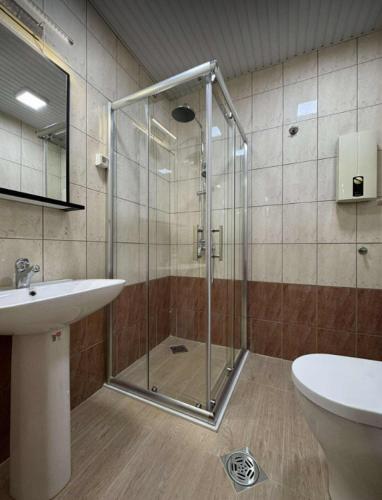 a bathroom with a glass shower and a sink at Apartment CityHeart in Ohrid