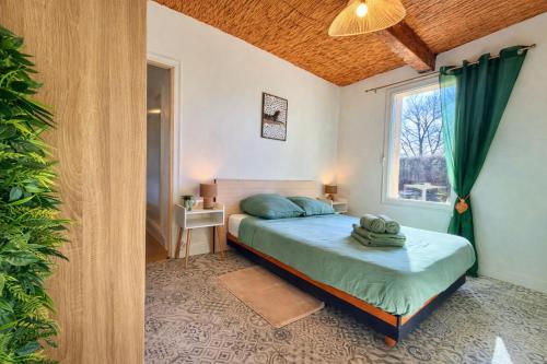 a small bedroom with a bed and a window at " Verdun Paradise " Jardin - Salle de Sport - Salle de Jeux in Verdun-sur-Garonne