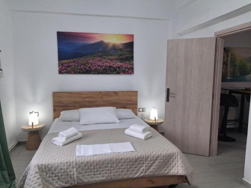 a bedroom with a bed with two towels on it at Villa Elia in Kástron