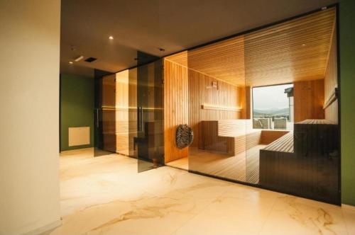 a large room with a large glass wall at BK Apartman in Zlatibor