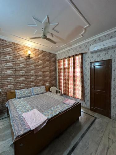 a bedroom with a bed and a ceiling fan at Serene Stay 22 in Chandīgarh