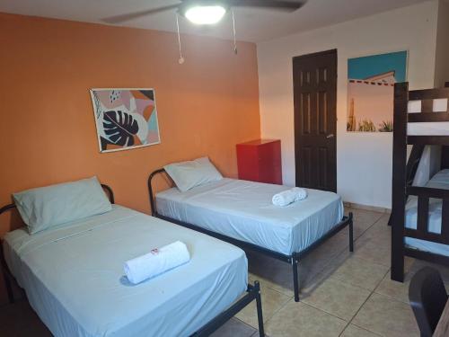 a room with two beds and a ladder at Casa Del Mar Pedasí in Pedasí Town