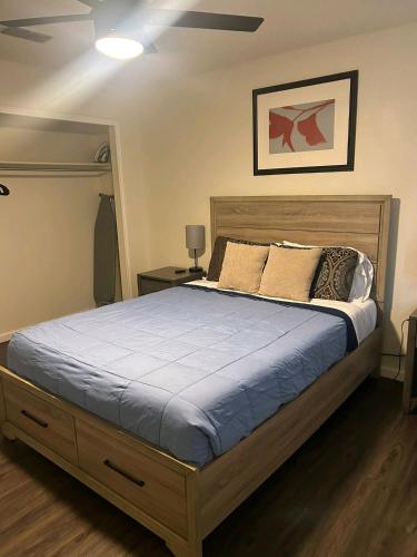 a bedroom with a large bed with blue sheets and pillows at FORT HAM: Just Like Home to SeaWorld MedVA in San Antonio