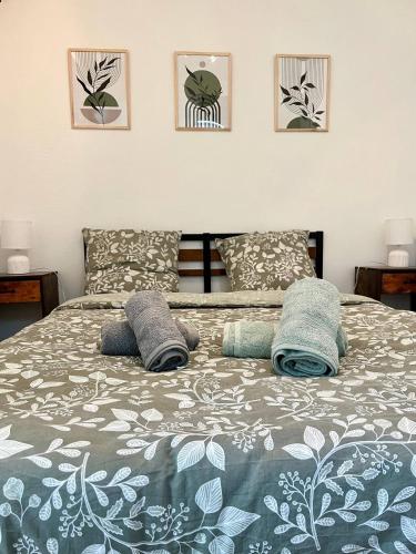 a bedroom with a bed with three pictures on the wall at Le refuge des Ormes in Les Ormes