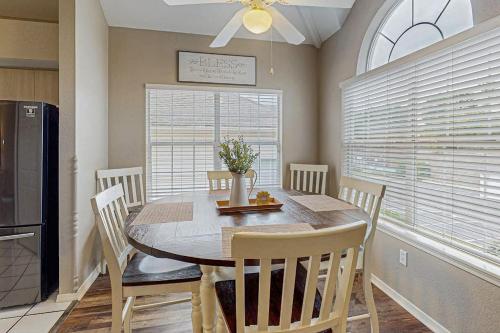 a dining room with a table and chairs and a window at On the Green in Branson