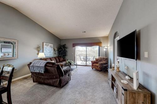 a living room with a couch and a tv at Thousand Hills - Family Getaway in Branson