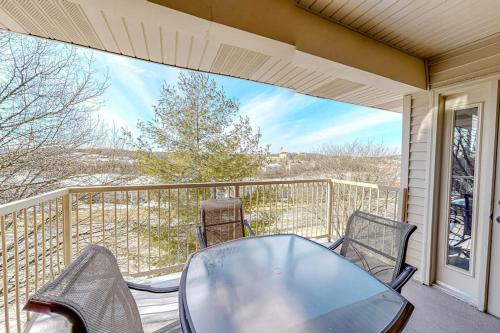 a porch with a table and chairs on a balcony at Thousand Hills - Family Getaway in Branson