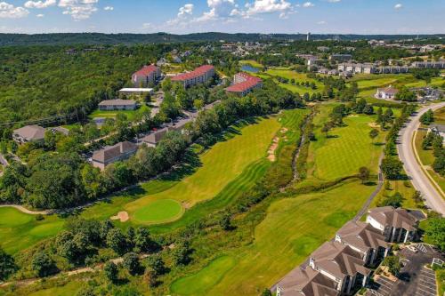 an aerial view of a golf course with houses at Thousand Hills Condo in Branson