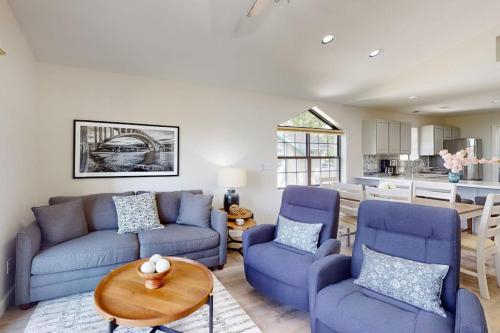 a living room with two blue couches and a table at Waterview Oasis in Branson