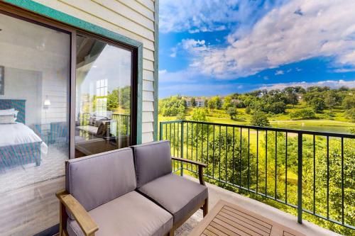 a balcony with a couch and a bed and a view at Waterview Oasis in Branson