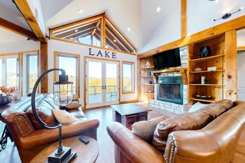 a living room with leather furniture and a fireplace at Treetop View Sanctuary in Branson