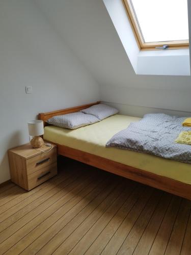 a bedroom with two twin beds and a window at Apartmani Bele breze in Adlešiči