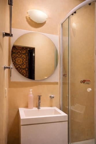 a bathroom with a sink and a mirror at Seven Nights Hostel Cartagena in Cartagena de Indias